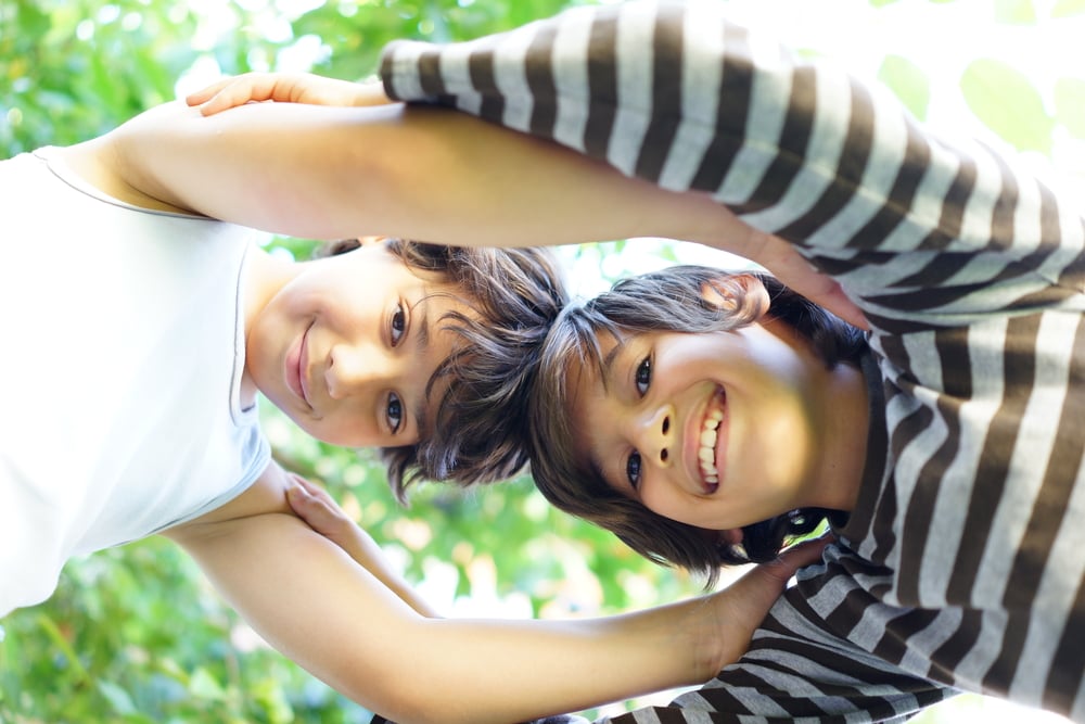 Two kids making a circle of trust and love